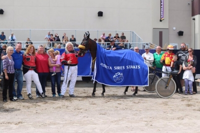 Trainer Harold Haining has a career day in the winner's circle at Century Downs
