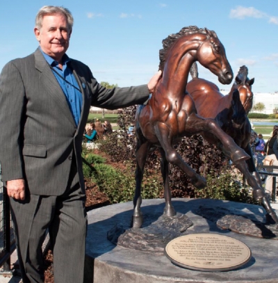 Ralph Klein, pictured standing beside the statue that was dedicated to him back in 2006.