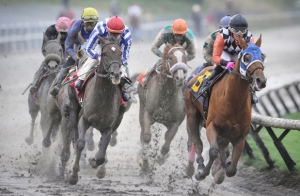 Ruben Lara aboard Killin Me Smalls (6) leads the pack at the B.C. Premiers race at muddy Hastings Racecourse in Vancouver on October 12, 2015